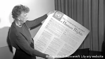 Eleanor Roosevelt holds a printed version of the Universal Declaration of Human Rights