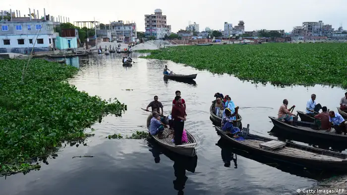 Bangladeshi commuters use boats to commute on the Buriganga river in Dhaka on September 18, 2012. Large amounts of water hyacinths have hampered the movement of boats on the river for the thousands of commuters that use them. AFP PHOTO/Munir uz ZAMAN (Photo credit should read MUNIR UZ ZAMAN/AFP/GettyImages)
