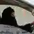 A woman drives a car on a highway in Riyadh, Saudi Arabia,