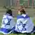 Two young women draped in Israeli flags in Auschwitz