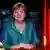 Канцлер ФРГ Ангела Меркель, букет цветов, флаги Германии и ЕС