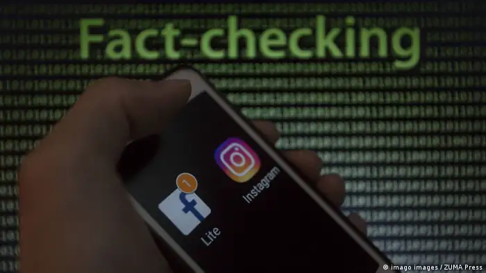 A hand is shown holding a smartphone displaying the Facebook and Instagram logos