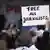 Protester holding up a sign reading "Free all journalists"