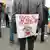 Участник акции протеста с антилукашенковским плакатом