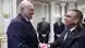 Рене Фазель (справа) пожимает руку Александру Лукашенко