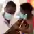 A nurse in Uganda draws a vaccine dose