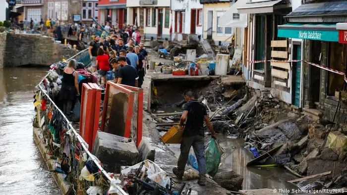 After the floods, police officers and volunteers clean rubble in Bad Muenstereifel, Germany, on July 18, 2021.