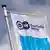 The Deutsche Welle logo hangs on a flagpole