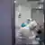  Afrigen Biologics, three people in white protective suits, facemasks and gloves in a lab and Vaccines in Kapstadt