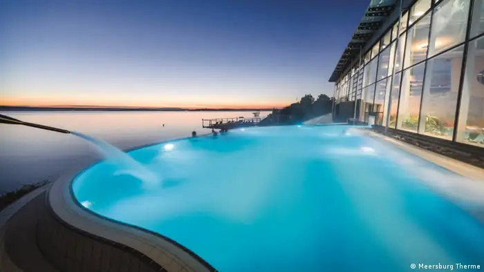 A pool lit up at night in Germany's Meersburg Therme.