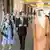 Isaac Herzog in a suit walks between his wife in a dress and Sheikh Abdullah bin Zayed Al Nahyan