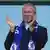 Roman Abramovich applauds with a Chelsea football scarf around his neck