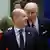 US President Joe Biden speaking to a smiling German Chancellor Olaf Scholz and tapping himo on the shoulder during a European Union leaders summit amid Russia's invasion of Ukraine, at the EU headquarters in Brussels, Belgium March 24, 2022