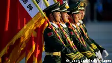 BEIJING, CHINA - SEPTEMBER 03: Paramilitary policemen carrying flags prepare in front of the Tiananmen Gate ahead of the military parade to mark the 70th Anniversary of the end of World War Two on September 3, 2015 in Beijing, China. China is marking the 70th anniversary of the end of World War II and its role in defeating Japan with a new national holiday and a military parade in Beijing. (Photo by Jason Lee - Pool/Getty Images)