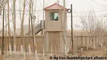 FILE - A security person watches from a guard tower around a detention facility in Yarkent County in northwestern China's Xinjiang Uyghur Autonomous Region on March 21, 2021. Allegations of human rights abuses in China's northwestern Xinjiang region are the dominant issue on a visit by the United Nations' top rights official that starts Monday, May 23, 2022. changes are needed to fight Islamic extremism. (AP Photo/Ng Han Guan, File)