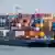 Груженный контейнерами грузовой корабль в порту Дуйсбурга