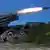 Russian servicemen fire a multiple rocket launch system