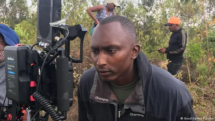 Director Vincent Mbaya watches a replay on the set of Country Queen