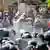 Water is sprayed above police and protesters in Bangkok