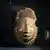 A sculpture of a face in bronze from Benin.