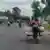 Des motos chargées de marchandises roulent dans une rue de Goma