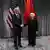 Chinese Vice Premier Liu He shakes hands with US Treasury Secretary Janet Yellen in front of US and Chinese flags