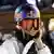 Austrian Anna Gasser smiles while wearing a snowboarding helmet an snow goggles