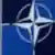 A Turkish flag flies next to NATO logo at the Alliance headquarters in Brussels