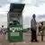 A man and a boy at an M-Pesa vendor box in Nairobi