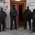 Zamaskowani policjanci stoją przed budynkiem w Berlinie
