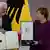 German President Frank-Walter Steinmeier (L) awards the Order of Merit to former German Chancellor Angela Merkel at the Bellevue presidential palace in Berlin on April 17, 2023.