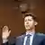 OpenAI Ceo Sam Altman raising right hand before testifying to US Congress