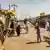 A donkey drawn cart moves along stalls of the Khartoum market
