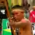 An Indigenous man aims an arrow during a protest rally