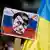 На плакате Путин в виде Гитлера на российском флаге