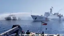 In this image taken from video provided by the Philippine Coast Guard, a Chinese Coast Guard ship, right, uses a water cannon on a Philippine Bureau of Fisheries and Aquatic Resources (BFAR) vessel as it approaches Scarborough Shoal in the disputed South China Sea on Saturday Dec. 9, 2023. The Philippines and its treaty ally, the United States, separately condemned a high-seas assault Saturday by the Chinese coast guard and suspected militia ships that repeatedly blasted water cannons to block three Philippine fisheries vessels from a disputed shoal in the South China Sea. (Philippine Coast Guard via AP)