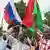 Several men hold up Burkinabe and Russian flag during a demostration