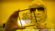 An employee works in the chip manufacturing process at a clean room of the Barcelona Institute for Microelectronics (IMB-CNM) in Bellaterra, near Barcelona, on March 3, 2022. - The Institute of Microelectronics of Barcelona (IMB-CNM) is the largest institute in Spain dedicated to the research and development of Micro and Nano Technology (MNTs) and microsystems, and with unique capacities of silicon semiconductor technology. It belongs to the Spanish National Research Council (CSIC) since its foundation in 1985. (Photo by Josep LAGO / AFP) (Photo by JOSEP LAGO/AFP via Getty Images)
