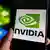 A Nvidia logo on a plackard held between a thumb and index finger