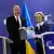 The EU's Ursula von der Leyen and the Ukrainian Prime Minister Schmyhal holding up a booklet titled Ukraine Plan