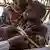 A health worker measures the arm of a child