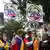 Protesters draped in Colombia flags hold up placards reading Petro Out