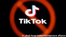 A ban sign displayed on a laptop screen and TikTok logo displayed on a phone screen are seen in this multiple exposure illustration photo taken in Poland on March 17, 2024. (Photo by Jakub Porzycki/NurPhoto)